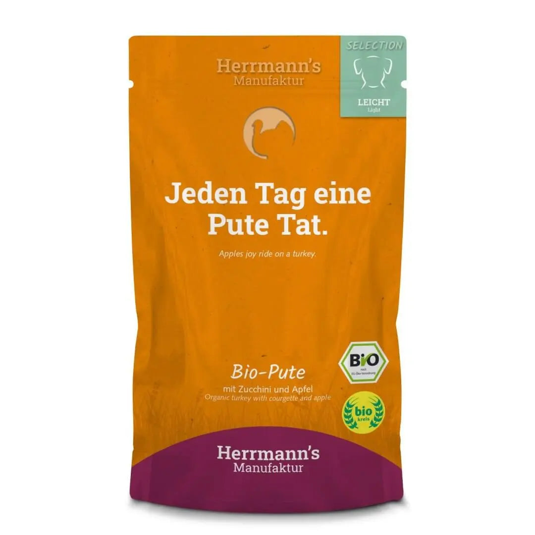 Opakowanie karmy Herrmann's Selection Bio Pute dla psa z logo bio i etykietą w języku niemieckim na pomarańczowym tle.
